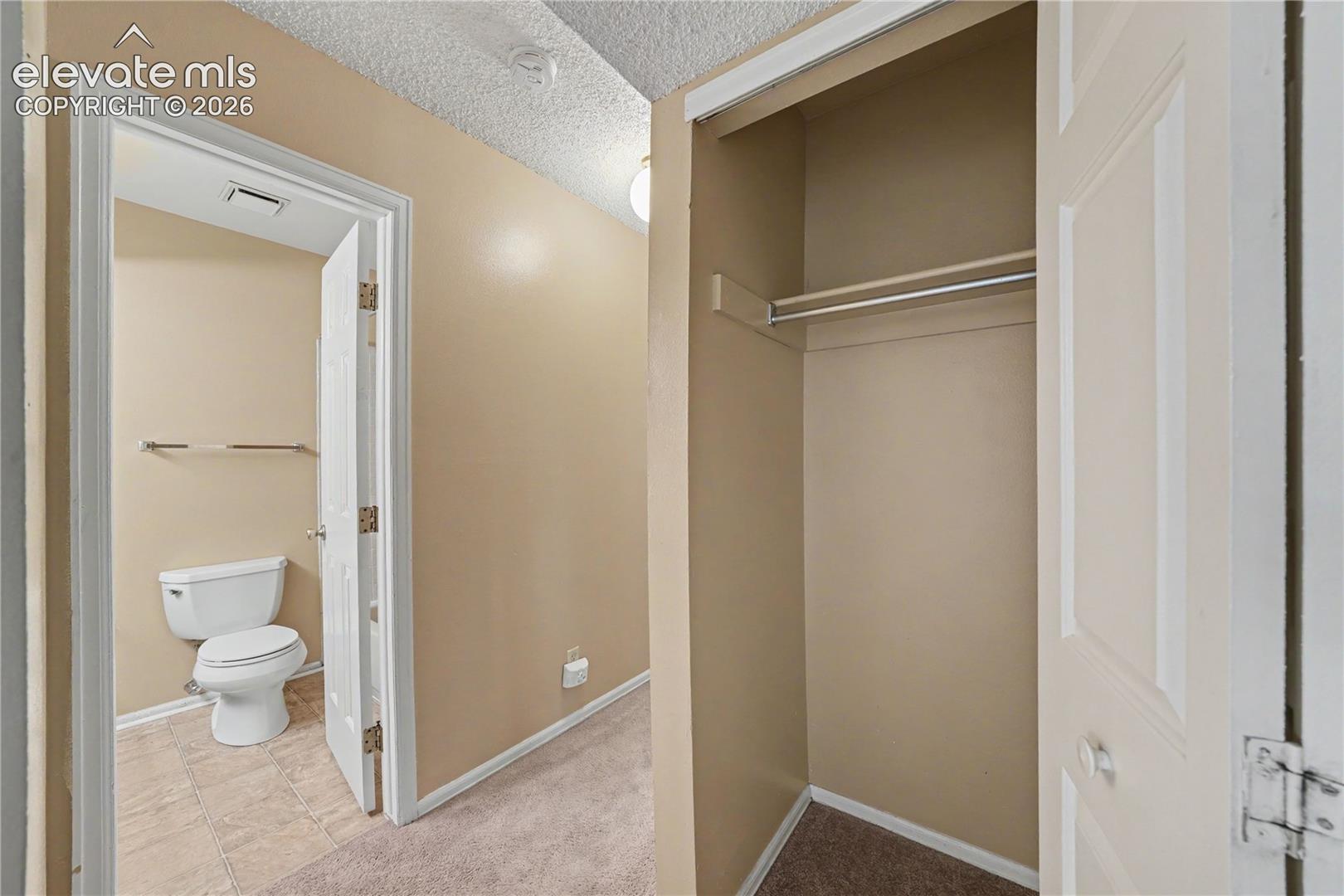 Bathroom entry with vanity and adjacent doorway
