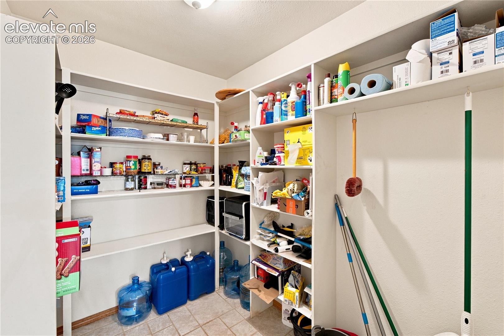 Built-in shelving with multiple levels, integrated storage solutions, and a neutral color palette