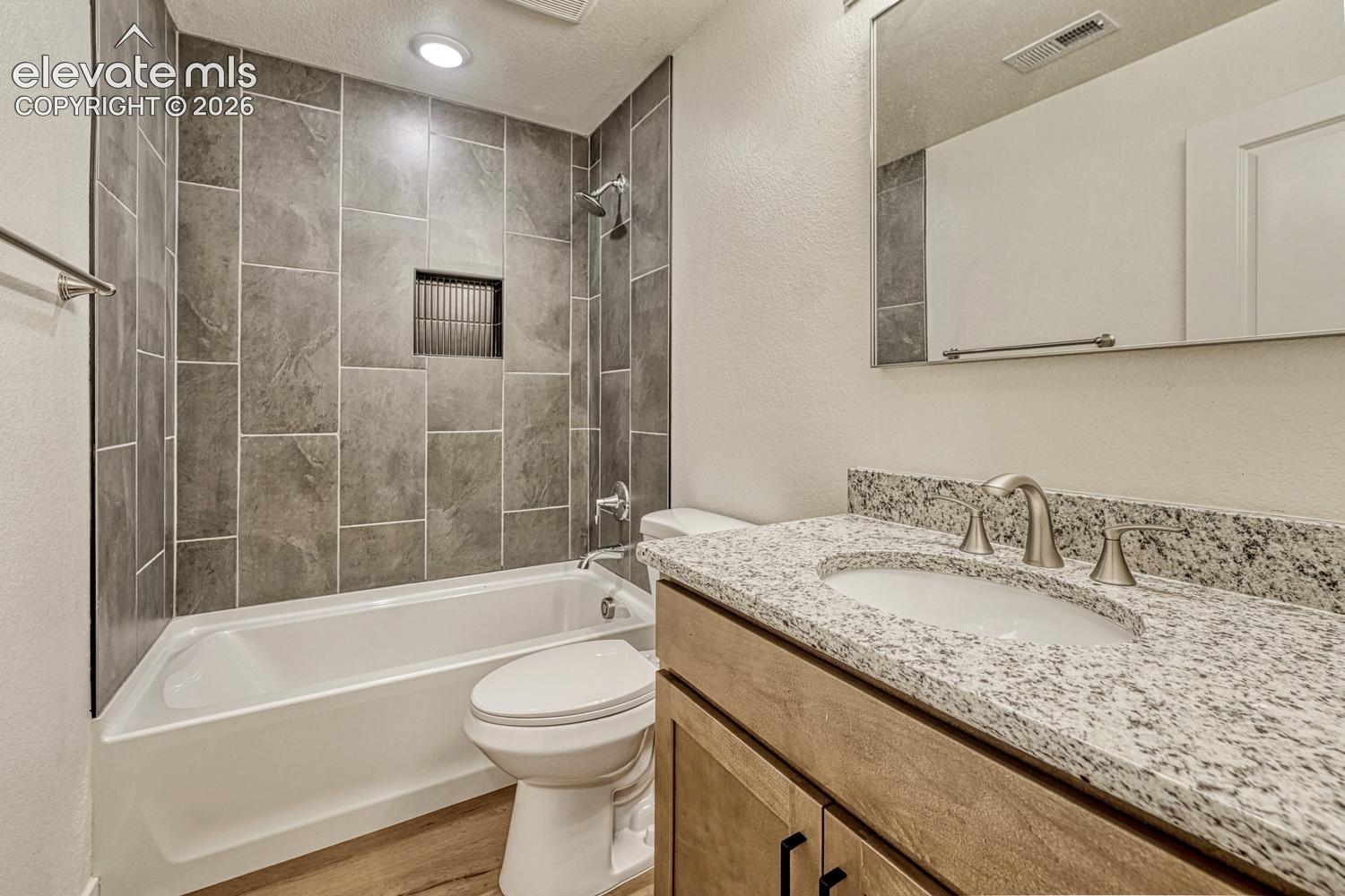 Full bathroom in the basement features granite counters and undermount sink