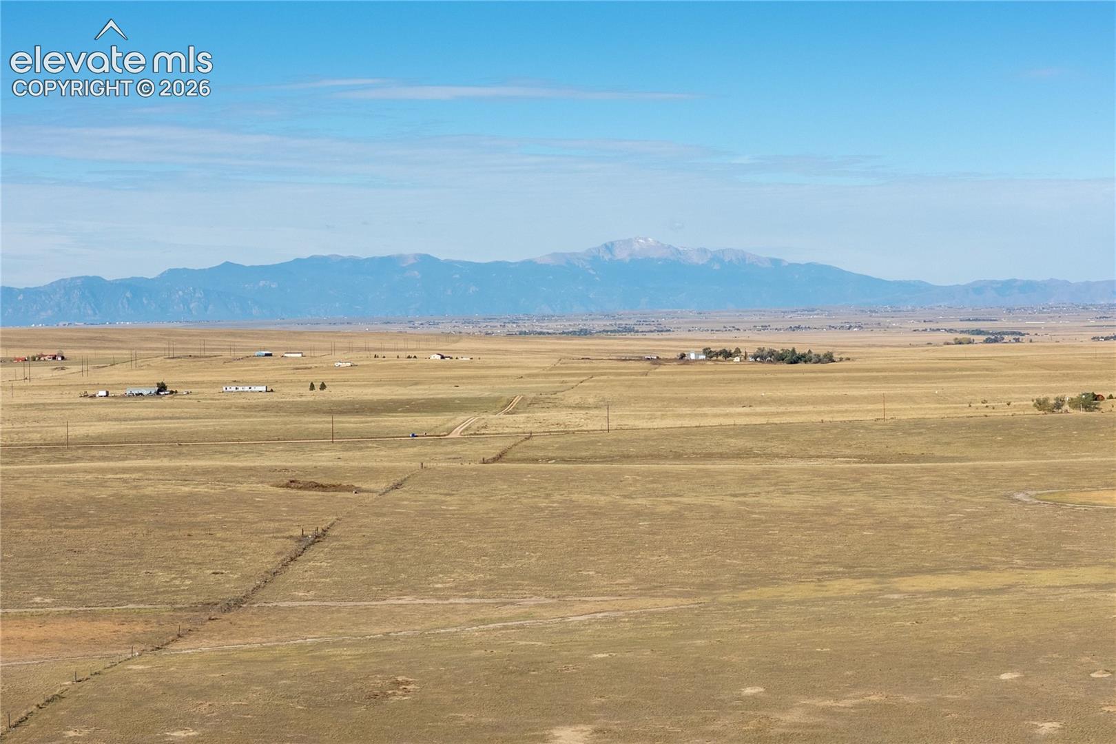 Expansive open acreage featuring mountain backdrops and clear horizon lines