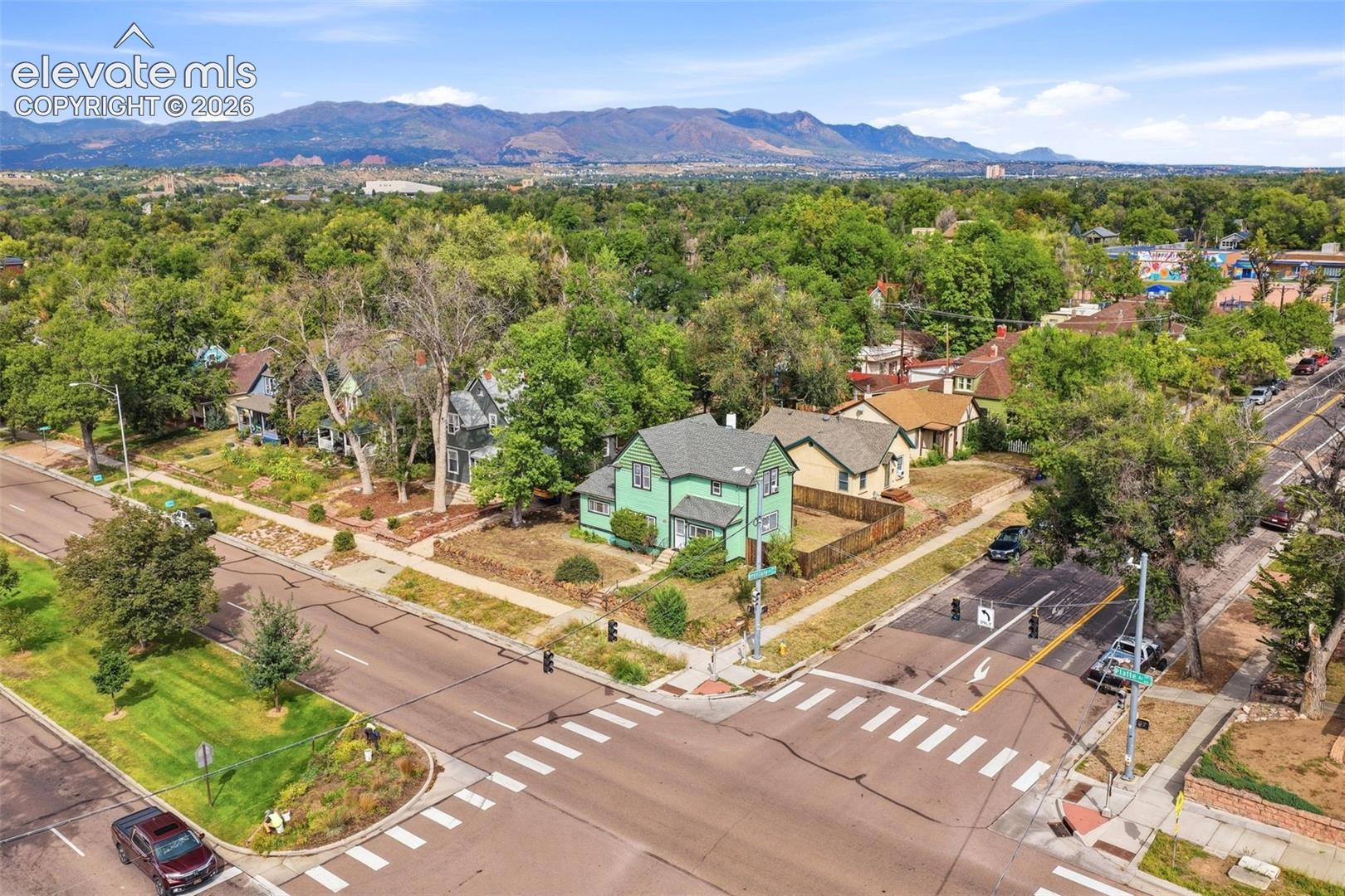 Corner lot property with a fenced backyard and established trees