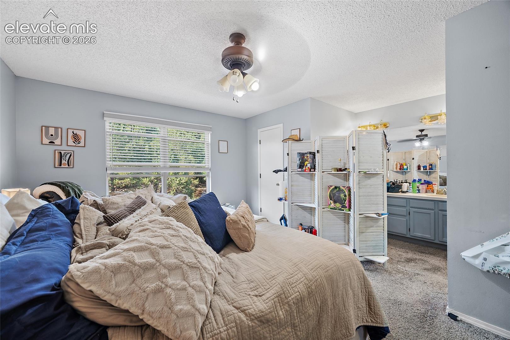 Recessed window with horizontal blinds, ceiling-mounted light fixture, and light-colored wall paint
