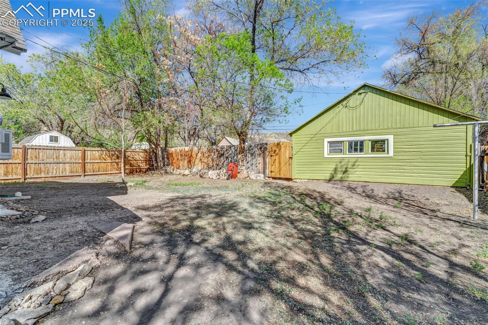 Freshly Painted Garage surrounded by mature trees