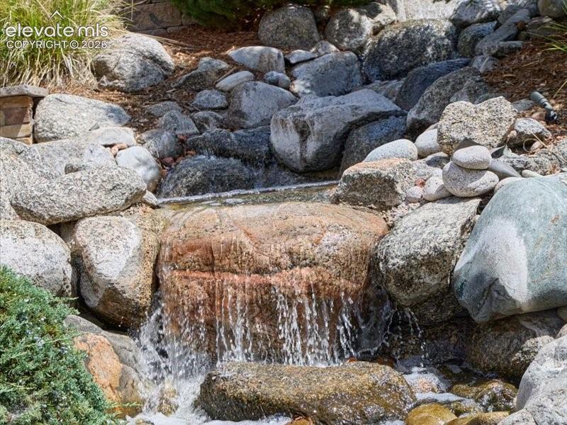 Natural rock water feature with cascading water and varied stone elements