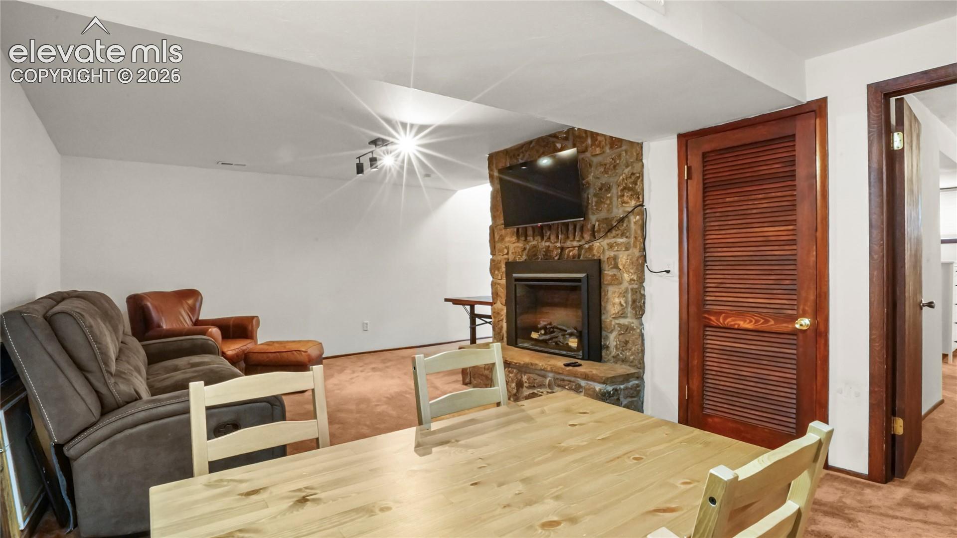 Basement showing a separate table with the fireplace.