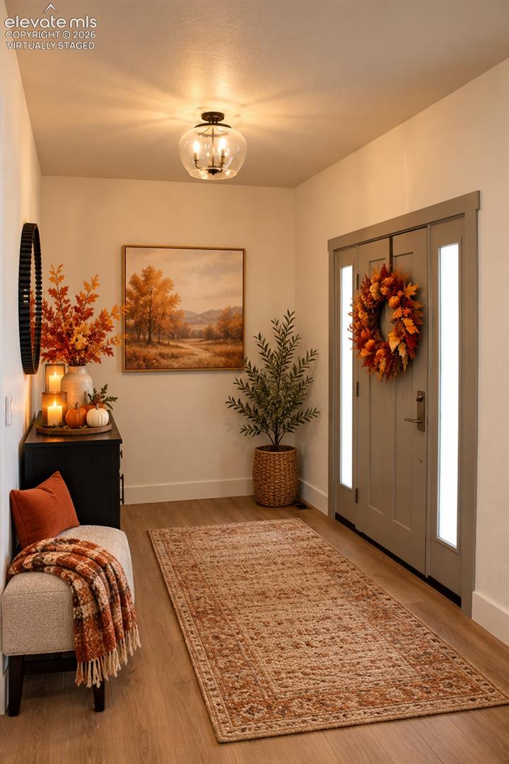 Virtually staged Wood-finish flooring, recessed lighting, and a front entry door with vertical glass inserts