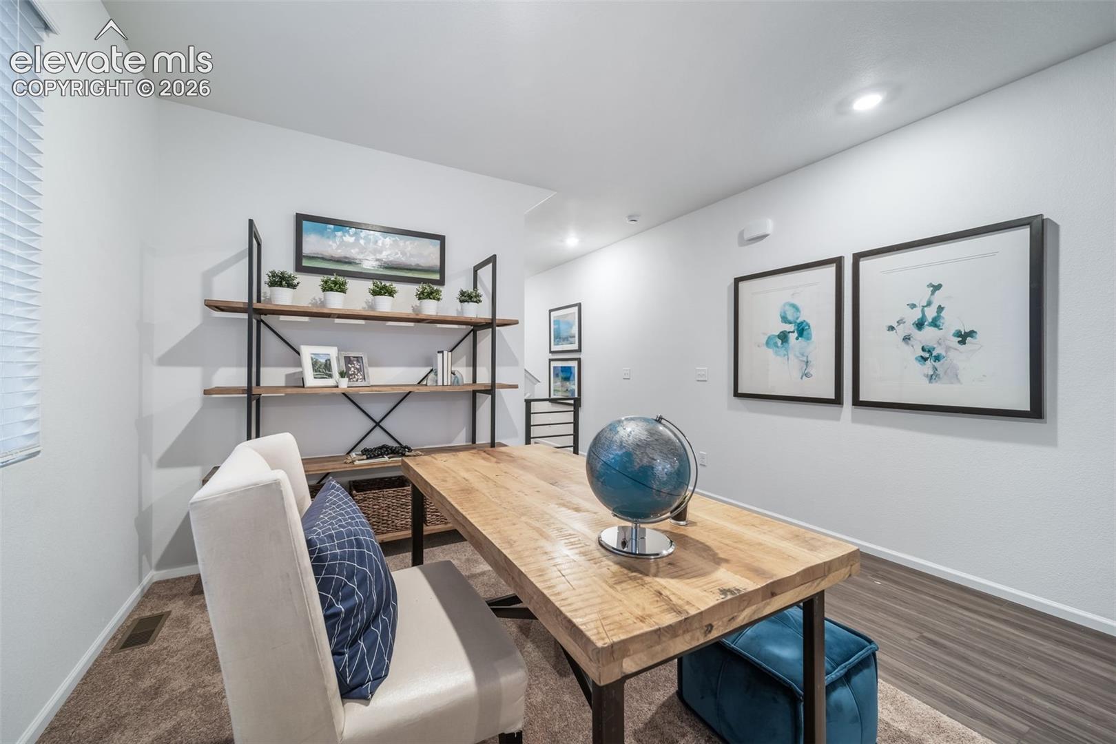 Wood-finish flooring, recessed lighting, built-in shelving with metal frame, window with blinds, and white painted walls
*photos of a model home*