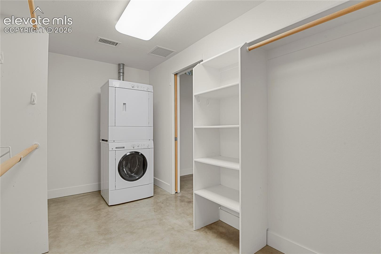 Massive walk-in closet directly off primary bedroom includes full size stackable laundry