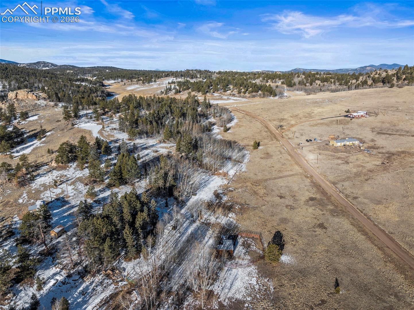 Aerial overview of property's location with mountains and rural landscape