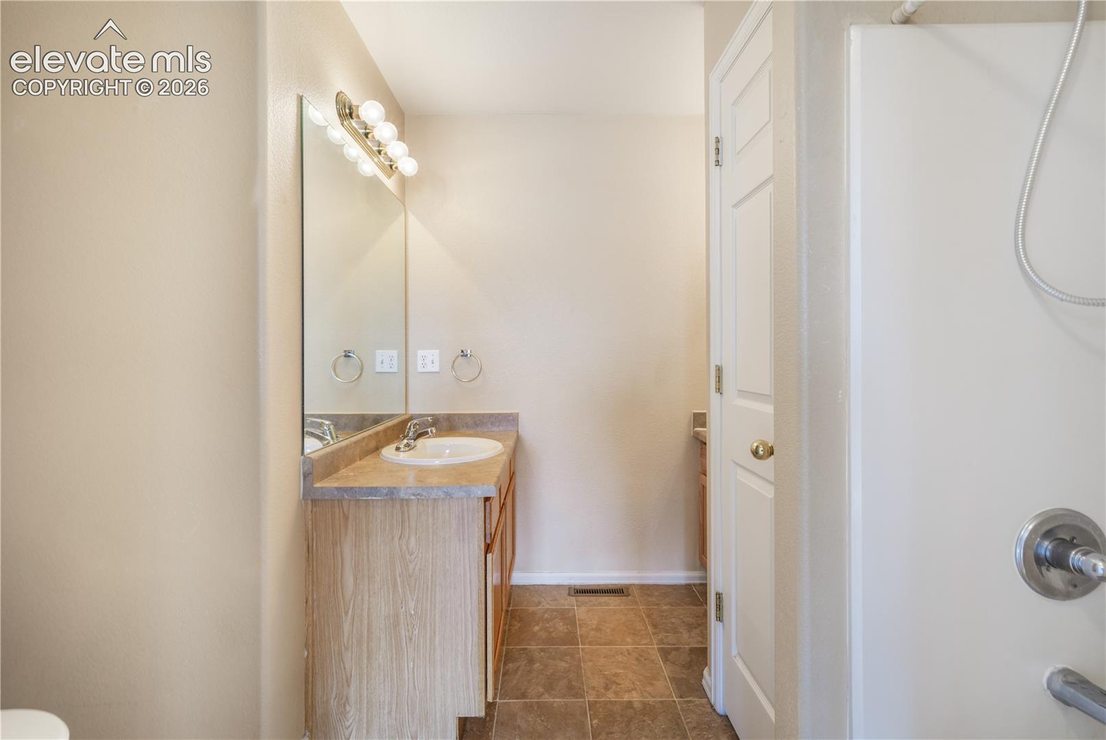 Main level primary ensuite bathroom 2 vanities, 2 separate showers