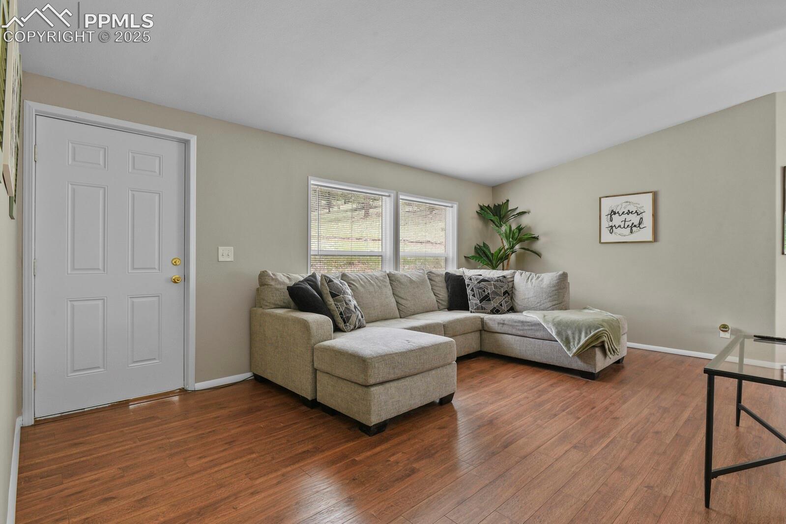 Living room with dark wood finished floors and lofted ceiling