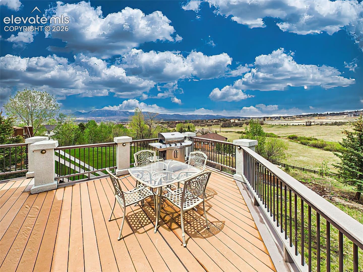 Elevated deck designed for entertaining with panoramic views of rolling open space and Colorado skies.