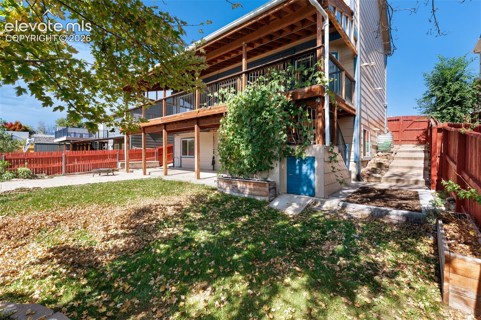 Multi-level wood deck structure with a lower patio area