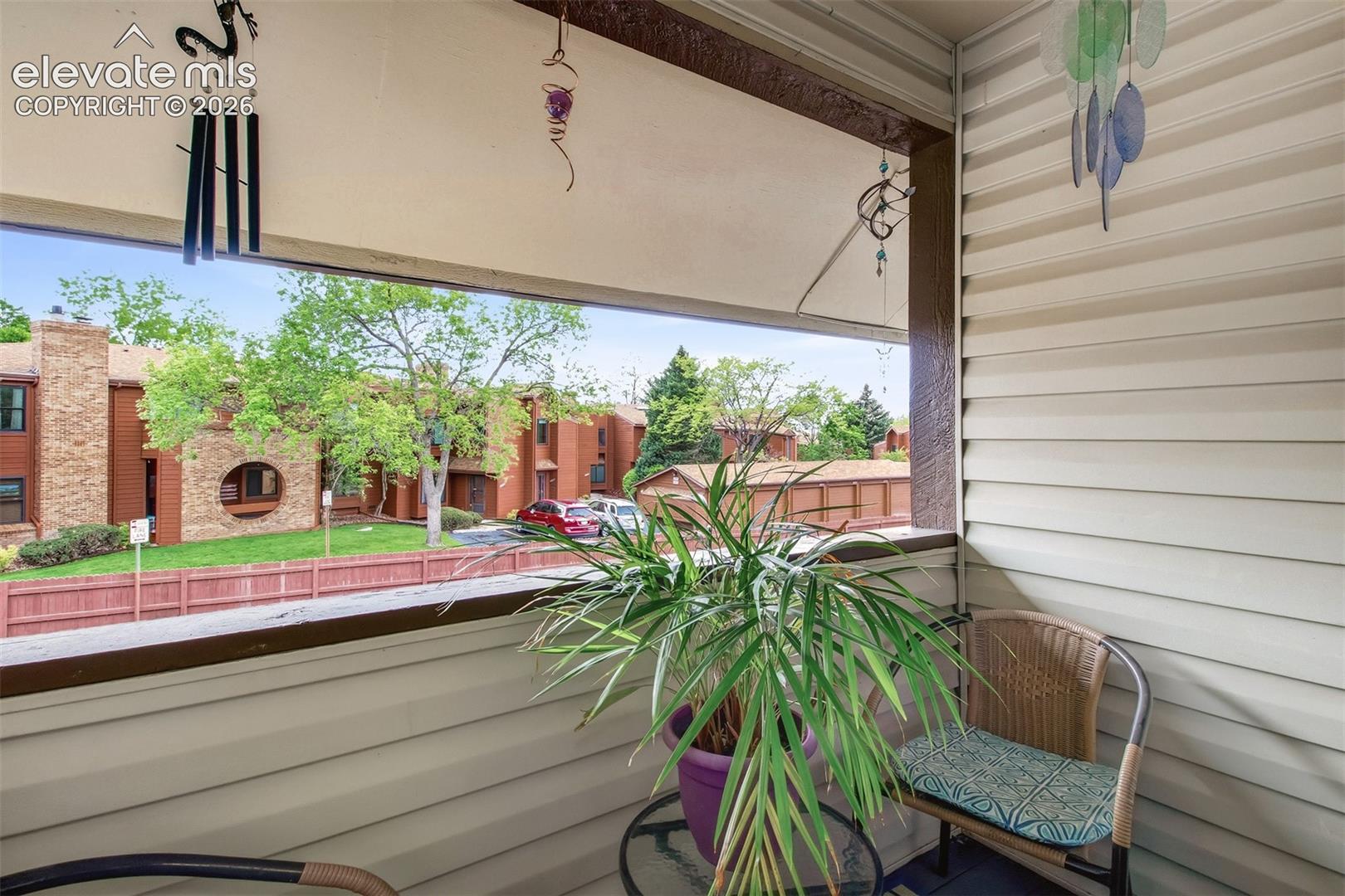 Covered balcony featuring horizontal lap siding, a metal railing, and an overhead beam