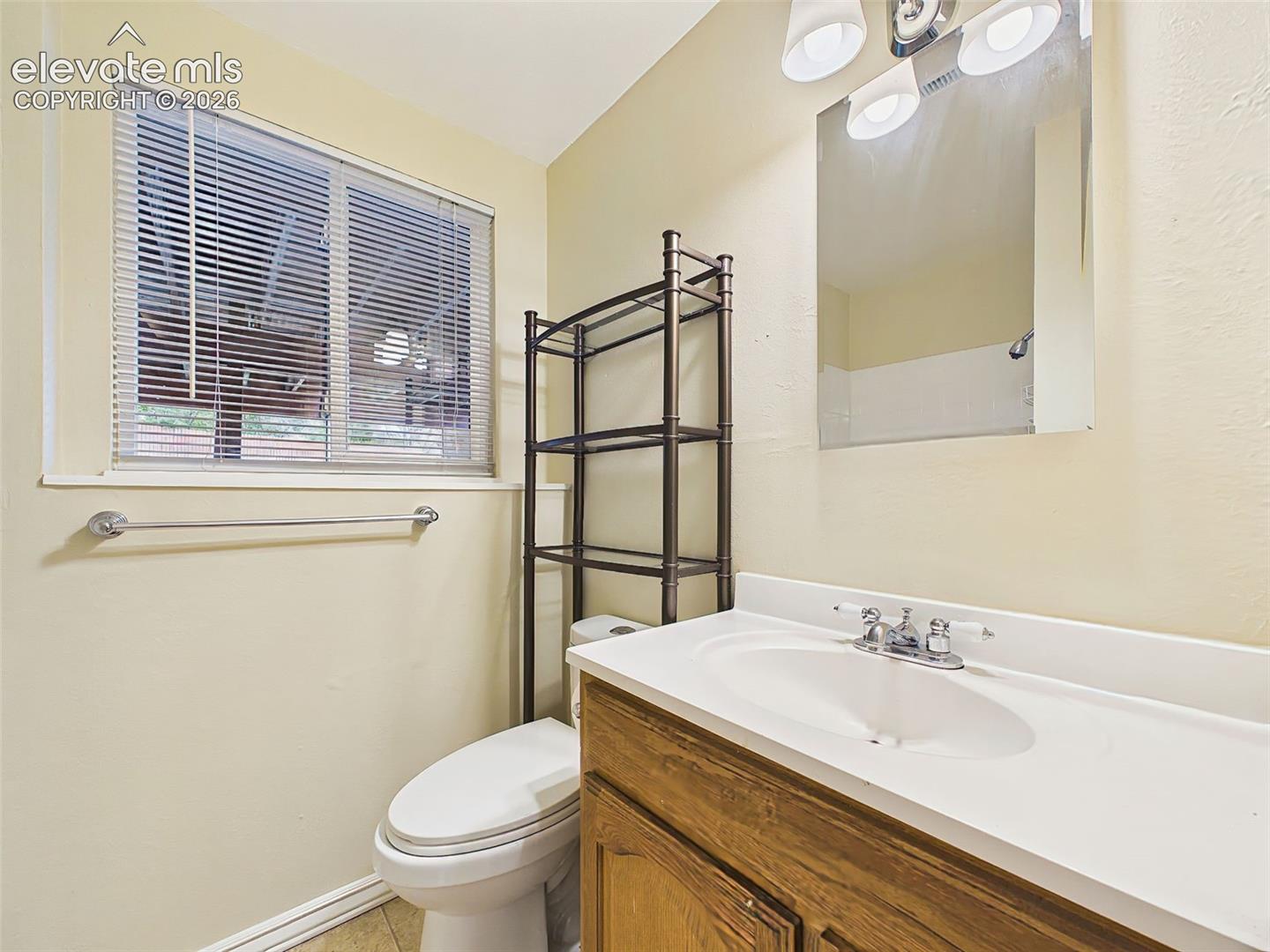 Vanity area offers additional storage, updated lighting, and convenient access from the adjacent living spaces.