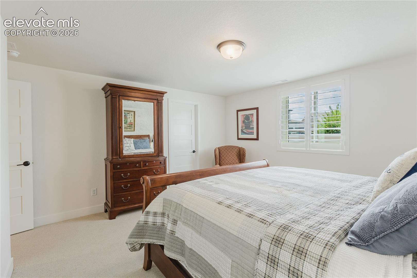 Bedroom in the lower level with plantation shutters and a walk in closet