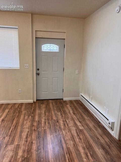Wood-finish flooring, interior door with decorative glass inlay, and horizontal blind window treatment