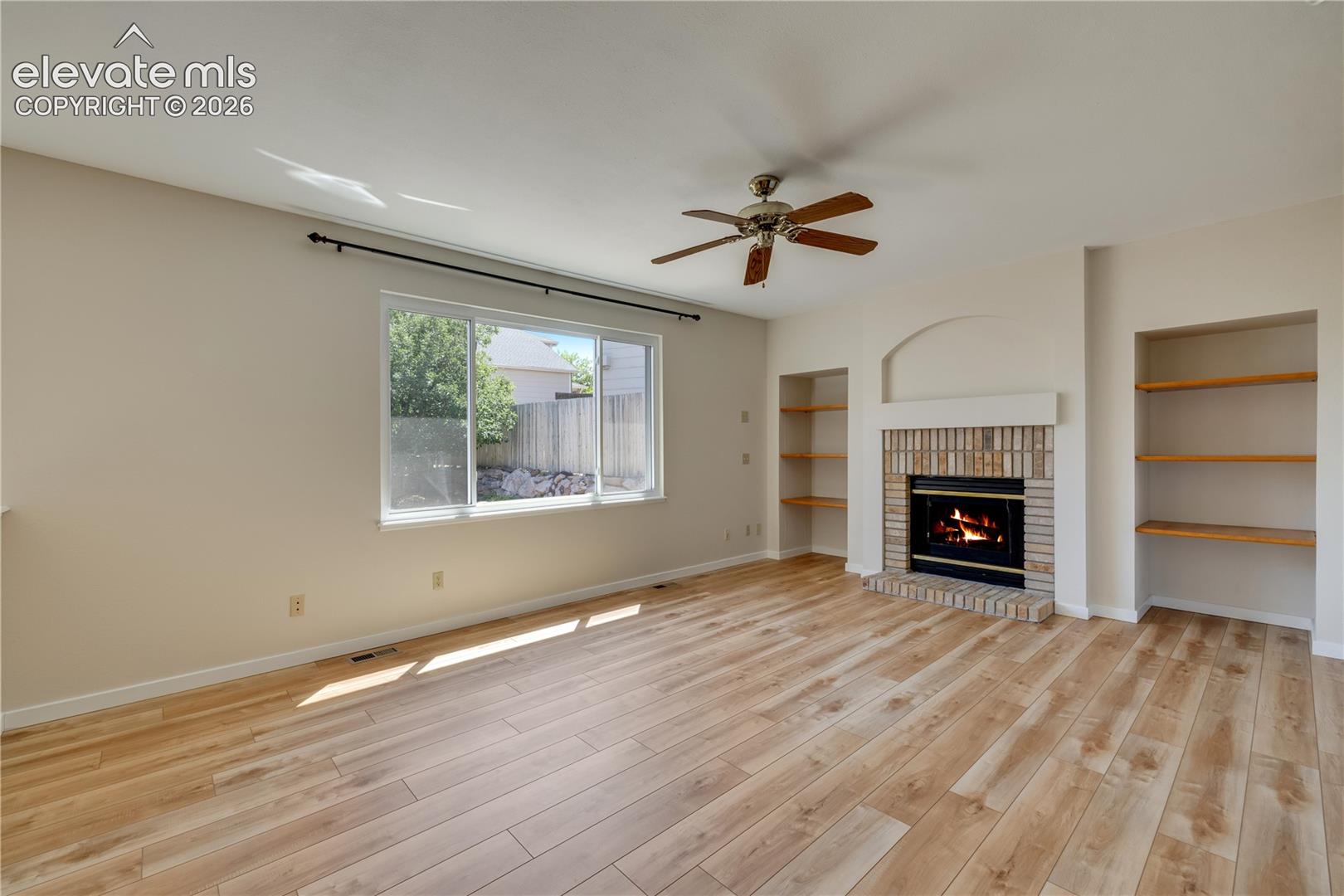 Main level family room has new luxury vinyl plank flooring and gas fireplace