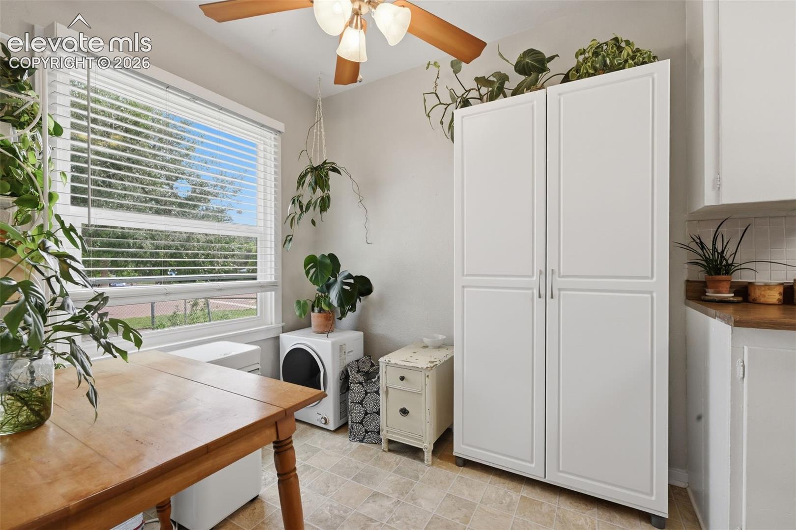 Recessed lighting with a ceiling fan, white window blinds, white storage cabinetry, and durable tile flooring