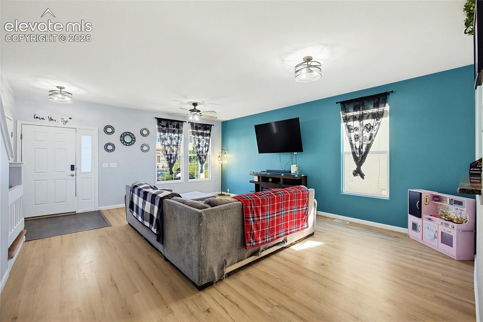 Wood-finish flooring throughout, bright walls, and a recessed window