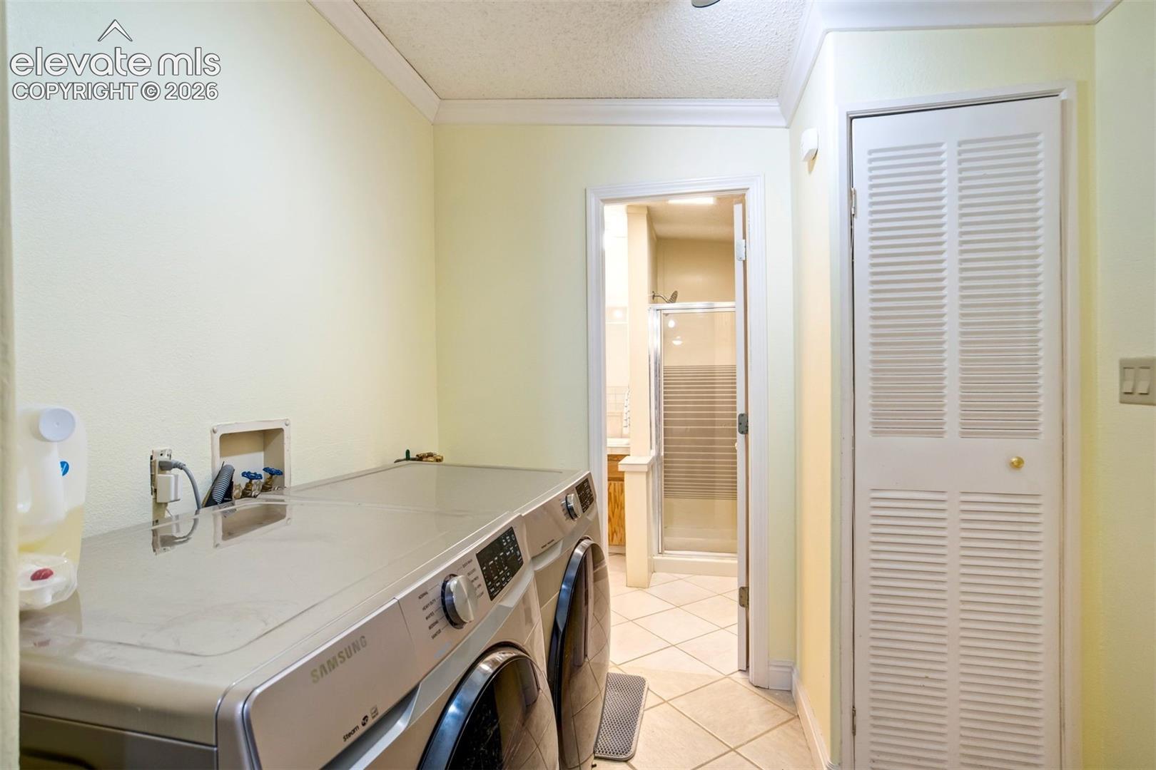 Convenient laundry area located near the primary suite for added functionality.