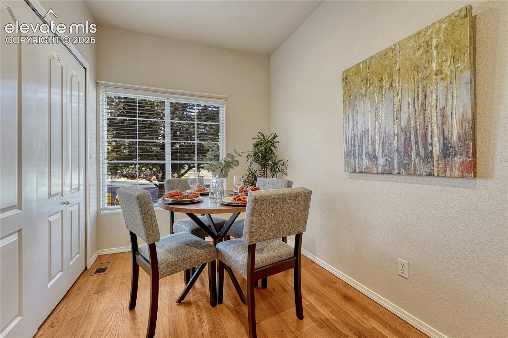 A charming breakfast nook off the kitchen provides a cozy, sunlit spot for everyday dining with peaceful window views

