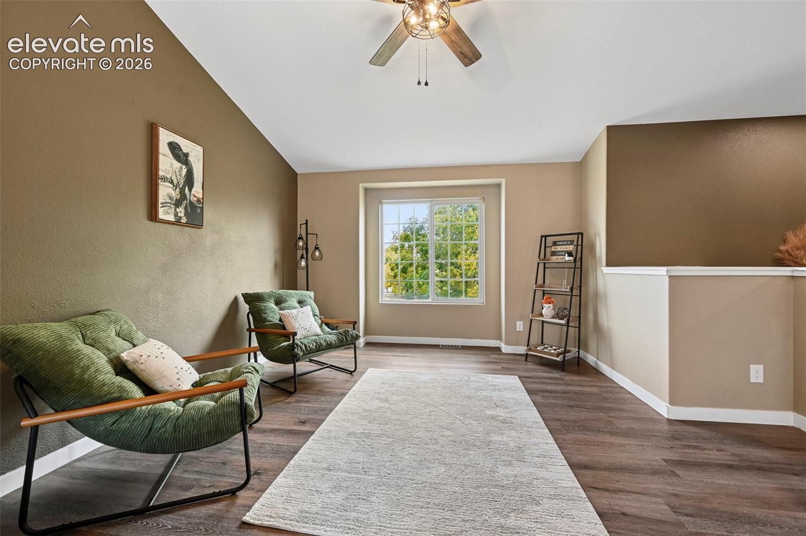 Vaulted ceilings, wood-finish flooring and ceiling fan with lighting