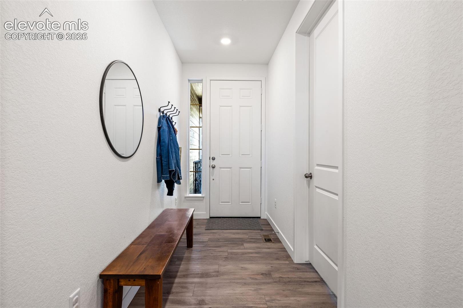 Entryway featuring LVP flooring, recessed lighting, and a window with natural light