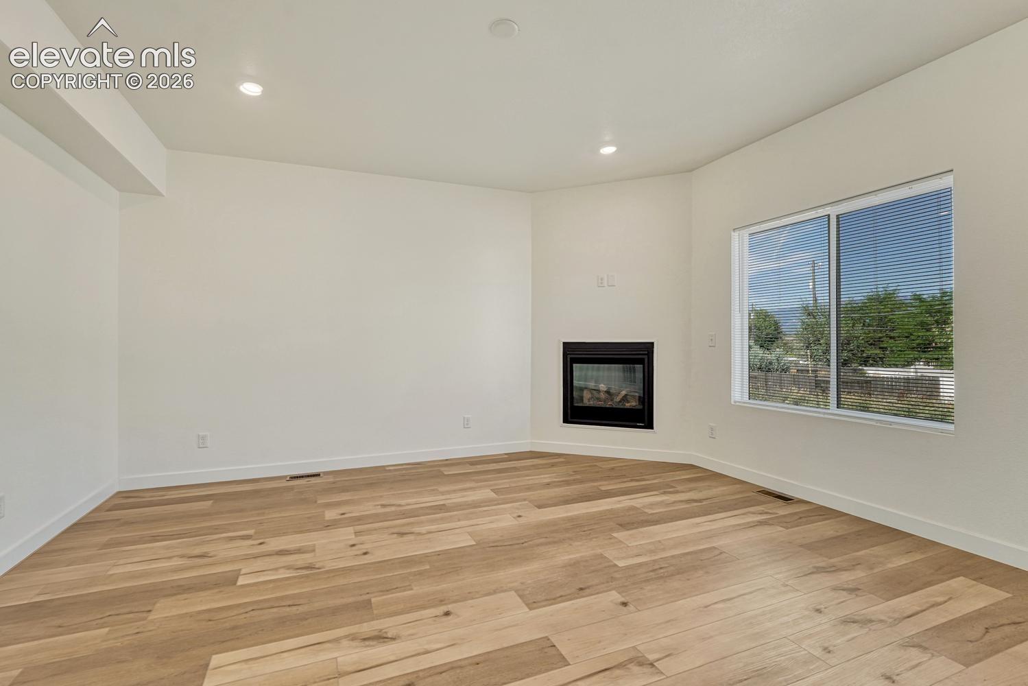Living room features a gas fireplace and durable LVP flooring