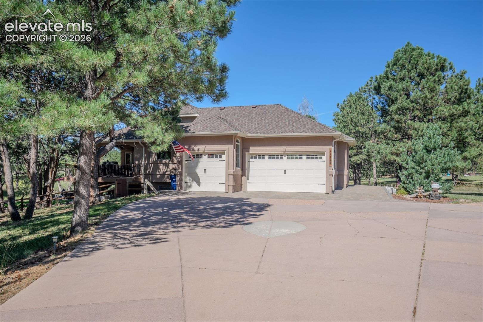 A 3-car attached garage. Notice the designed concrete driveway wide enough for multiple cars