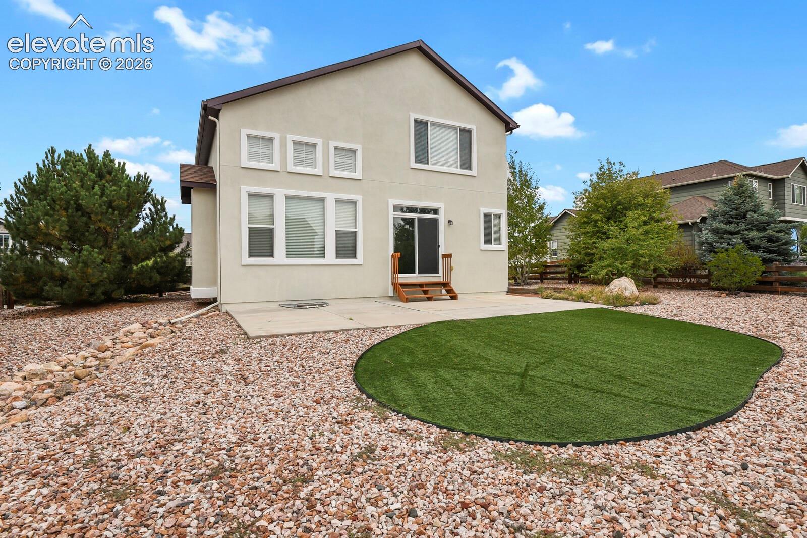 Rear exterior with stucco finish and a concrete patio