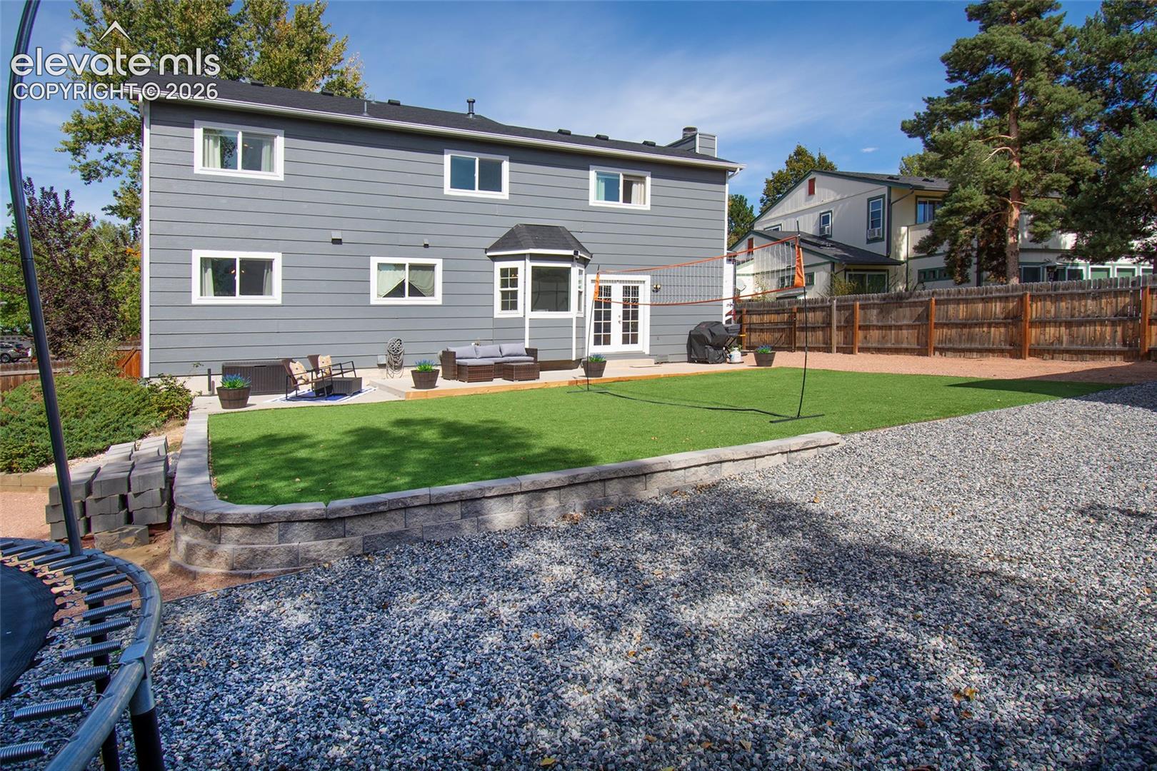 Fully fenced, landscaped backyard with year round green grass, decorative rock landscaping and 10 X 20 Shed!