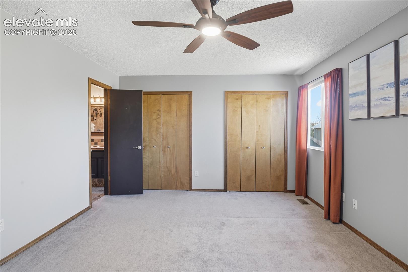 PRIMARY BEDROOM INCLUDES A PRIVATE BATH WITH TILED FINISHES AND A SOAKING TUB.