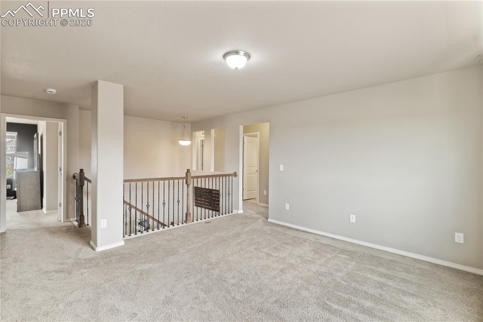 Empty room with carpet floors and baseboards