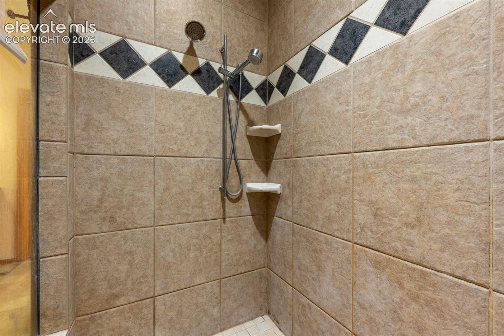 Beautifully oversized tiled shower.