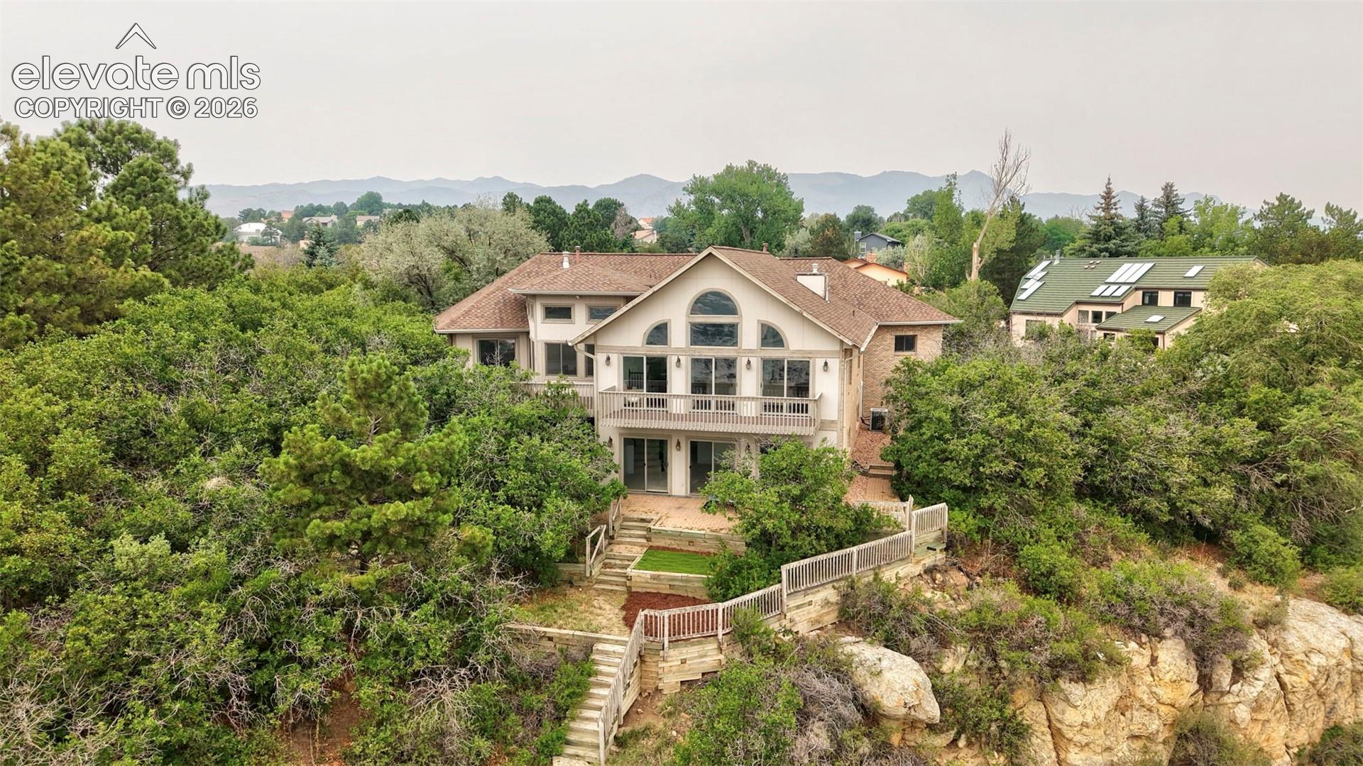 Multi-level residence with extensive natural landscaping and a terraced backyard