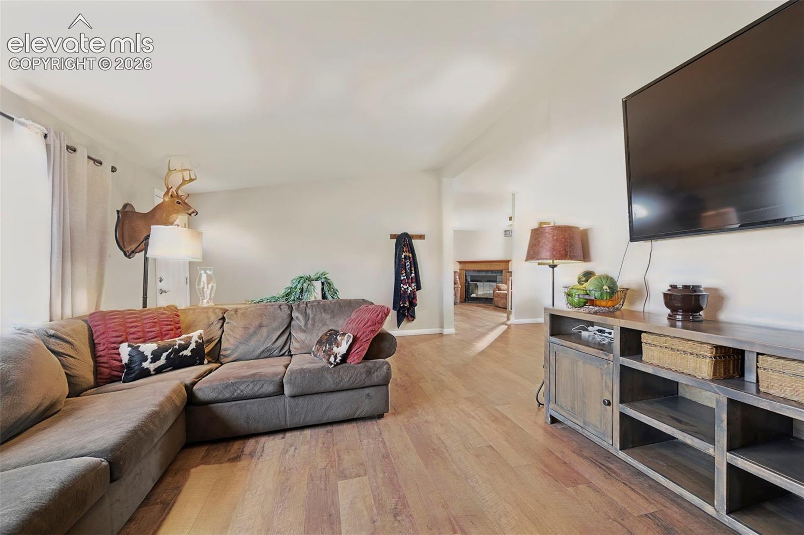 Neutral-toned walls paired with expansive wood-finish flooring