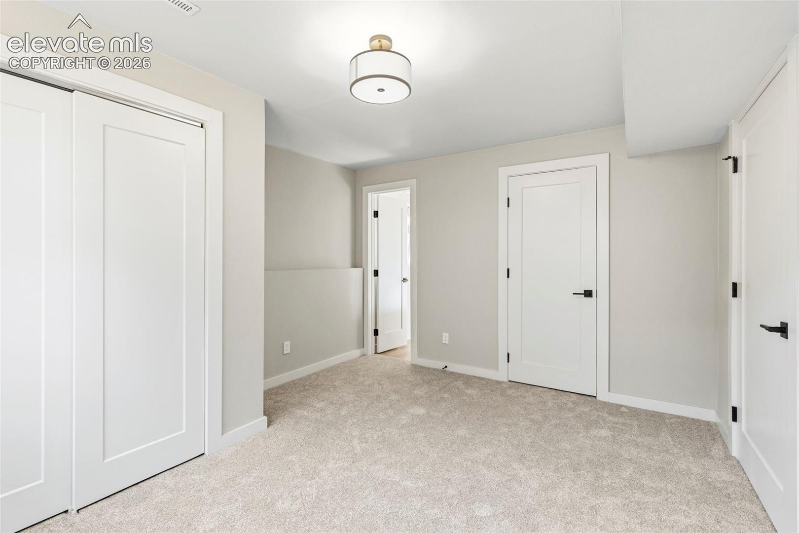 Plush taupe carpeting complements light grey walls