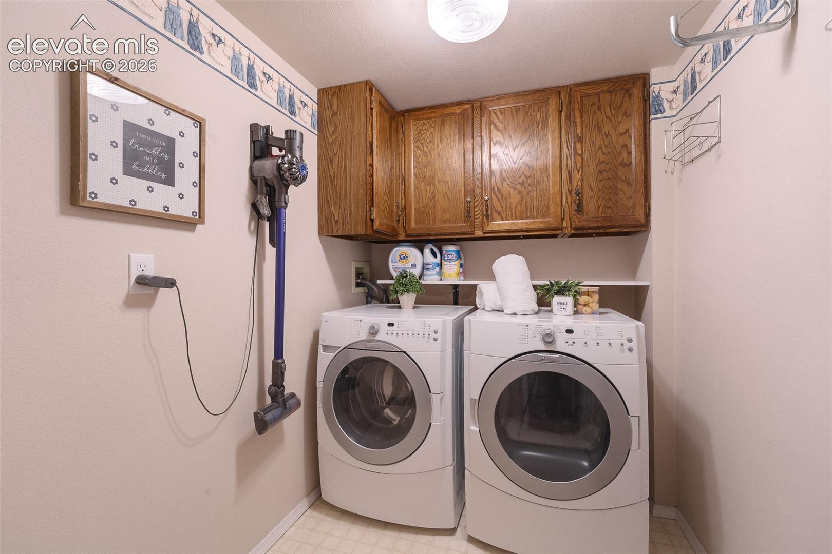 The Laundry Room features upper cabinets and a built-in shelf.