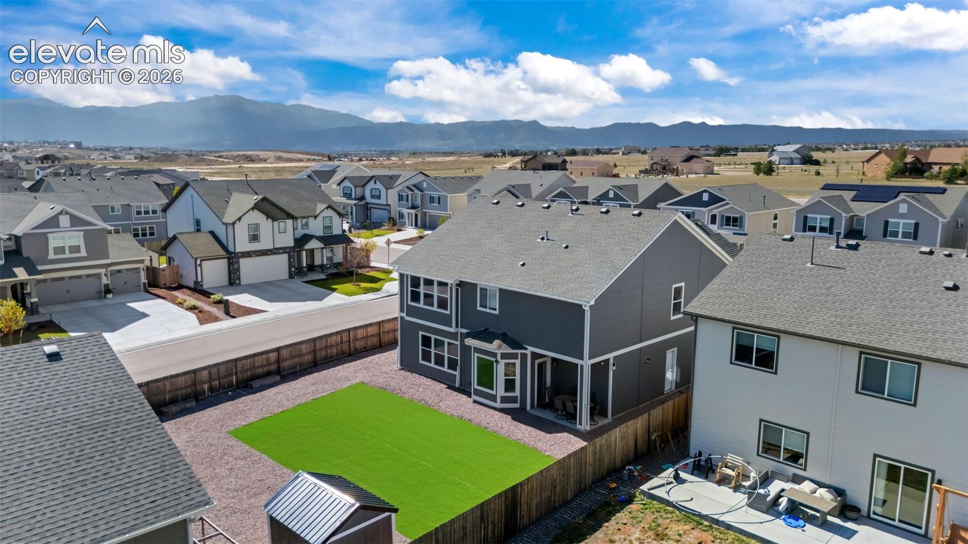 Expansive backyard with artificial turf and gravel landscaping