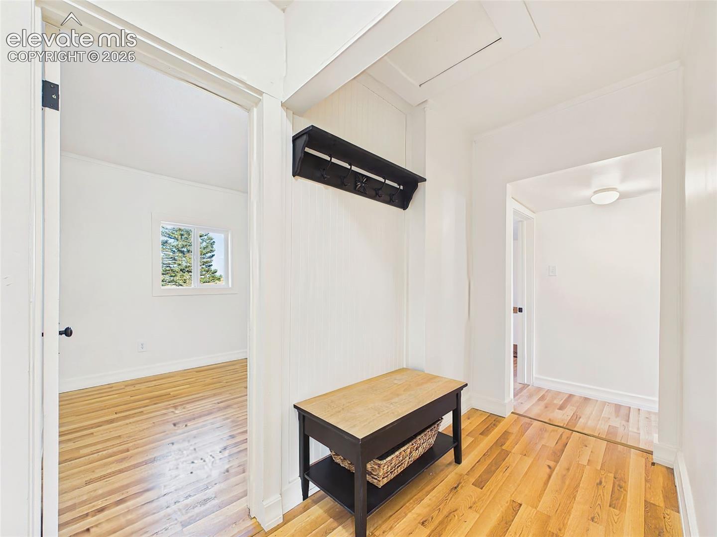 Mudroom/Hallway – Functional entry hallway includes a built-in bench and coat rack, creating a convenient drop zone for coats, shoes, and outdoor gear.