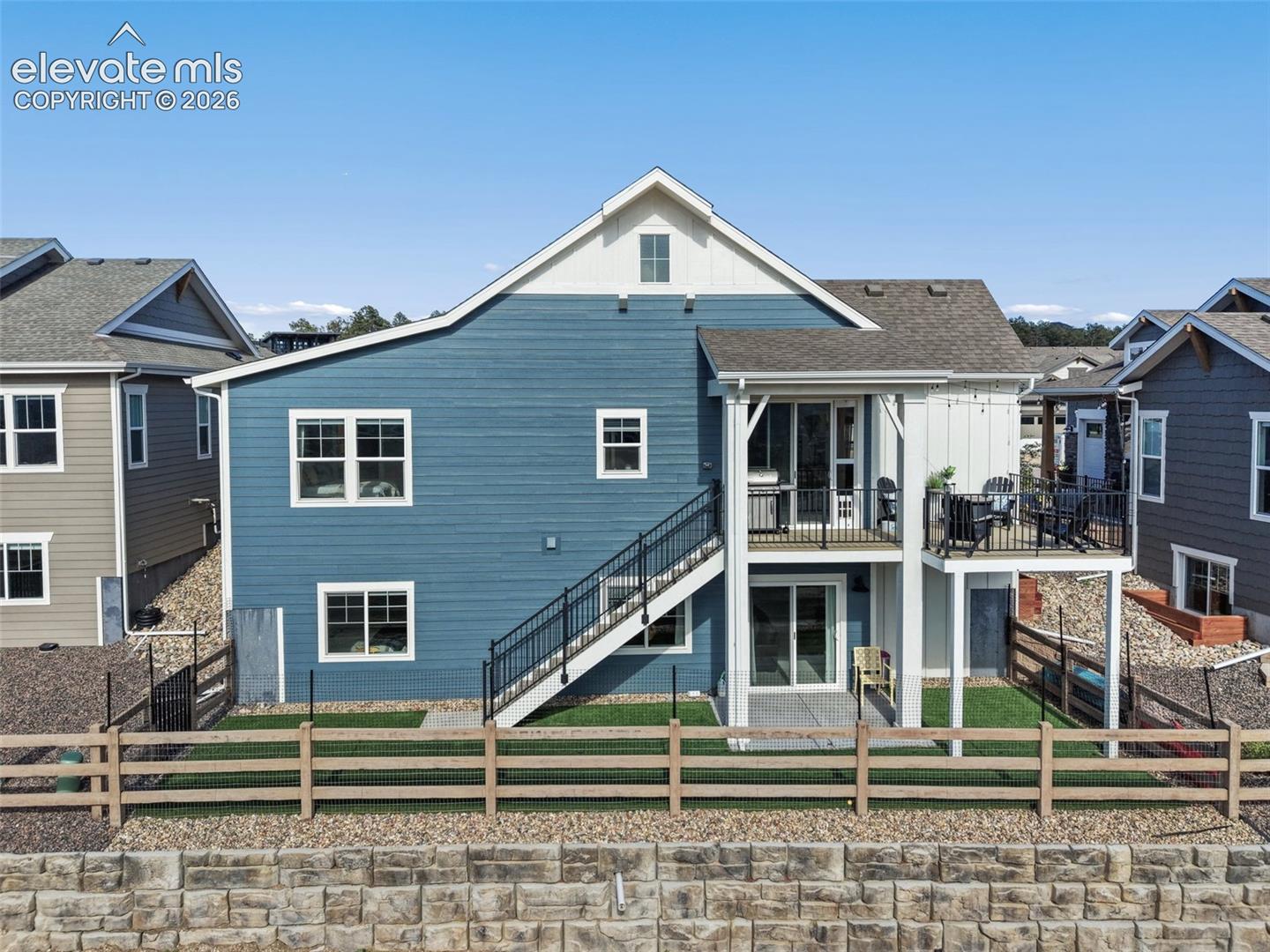 Back view of the house w/ luxury turf on the ground level