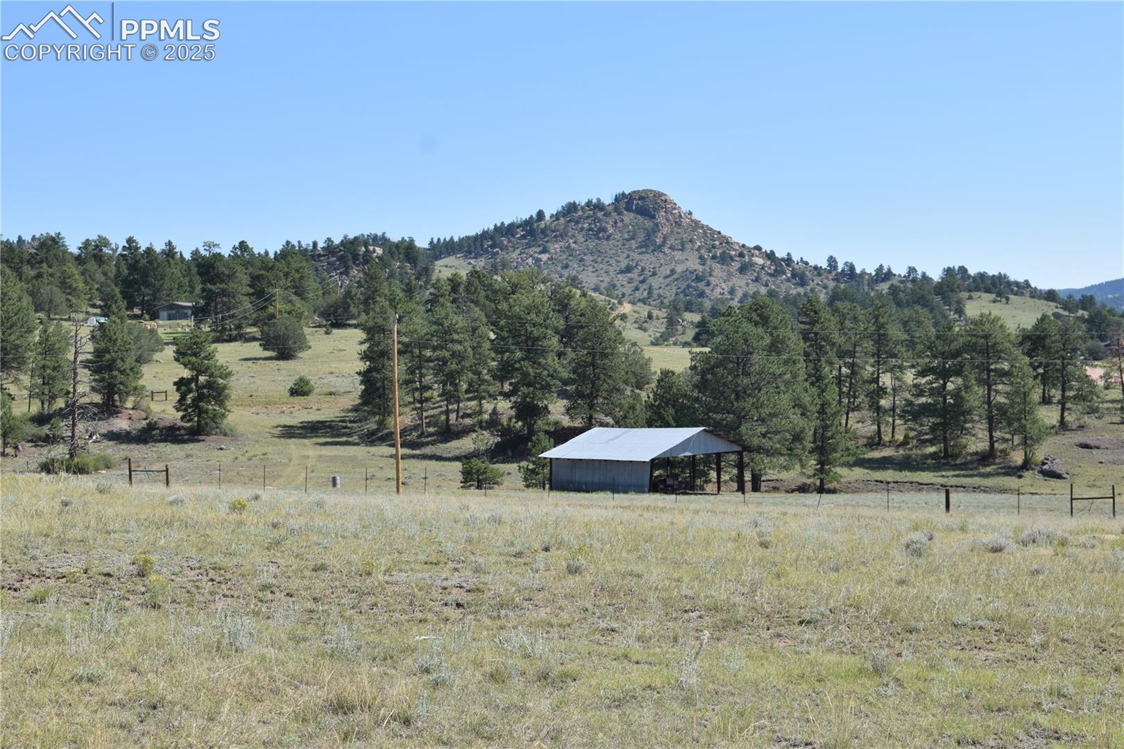 View of mountain backdrop featuring rural landscape