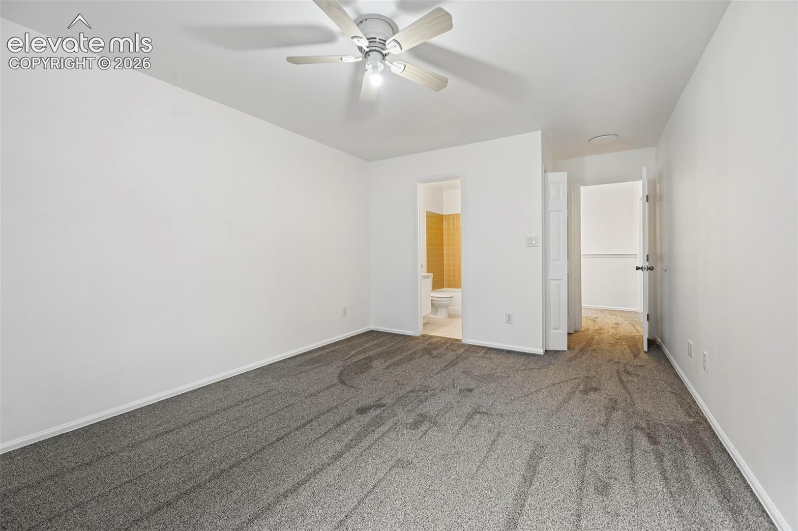 Neutral wall finishes, recessed lighting, and a ceiling fan with light fixture
