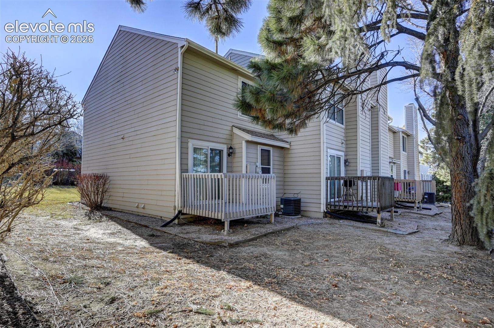 Side and backyard views of the end unit townhome.