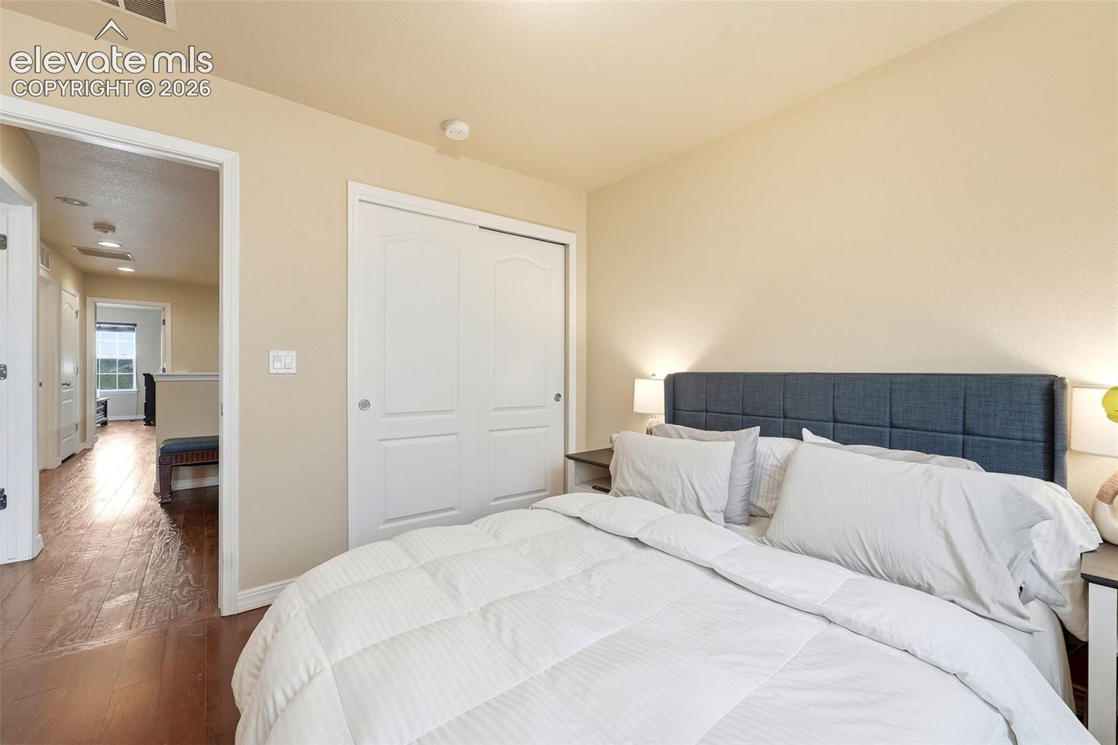 Neutral wall tones complemented by wood-finish flooring