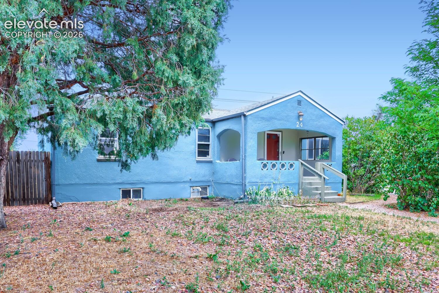 Light blue exterior with a covered porch featuring decorative concrete balusters