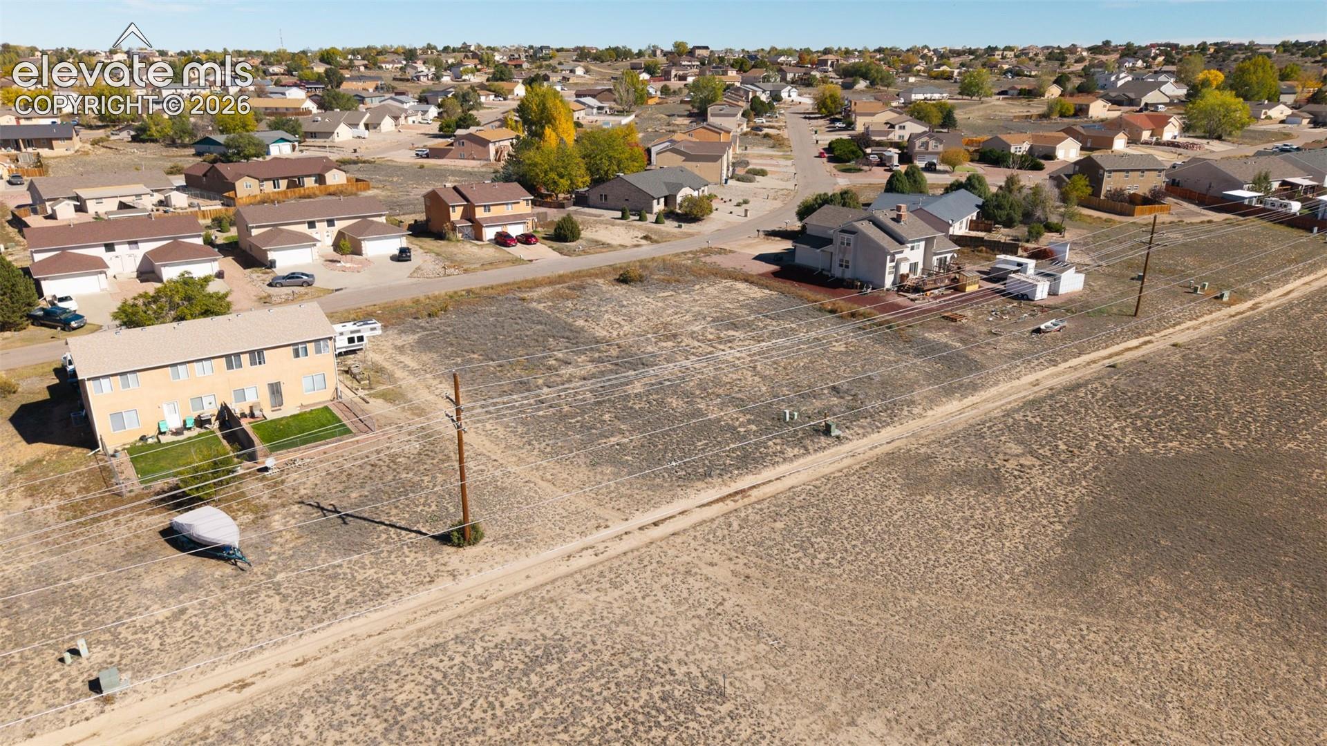 Expansive residential parcel featuring open terrain, level topography, and utility access points