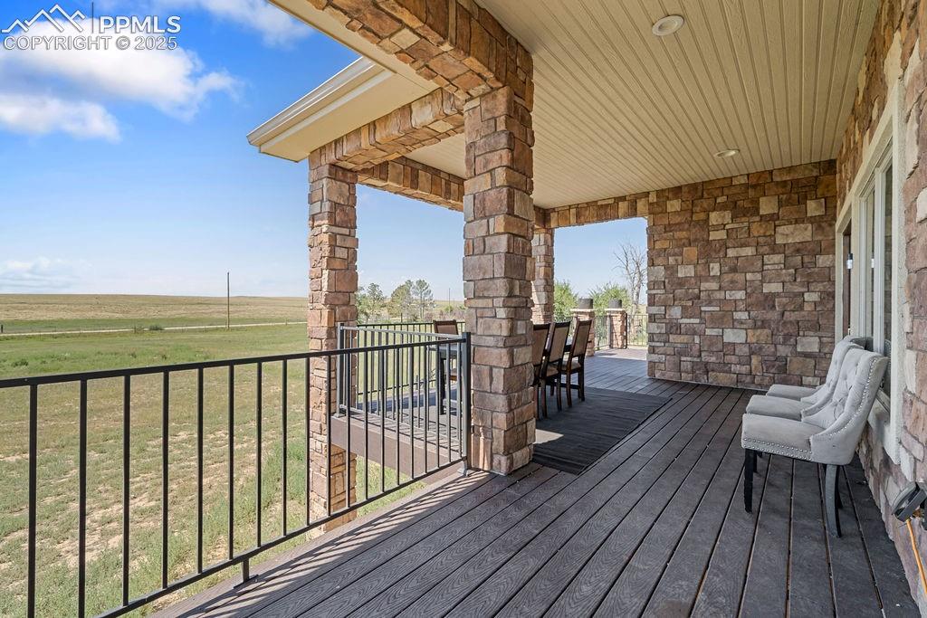 Deck featuring outdoor dining area and a yard