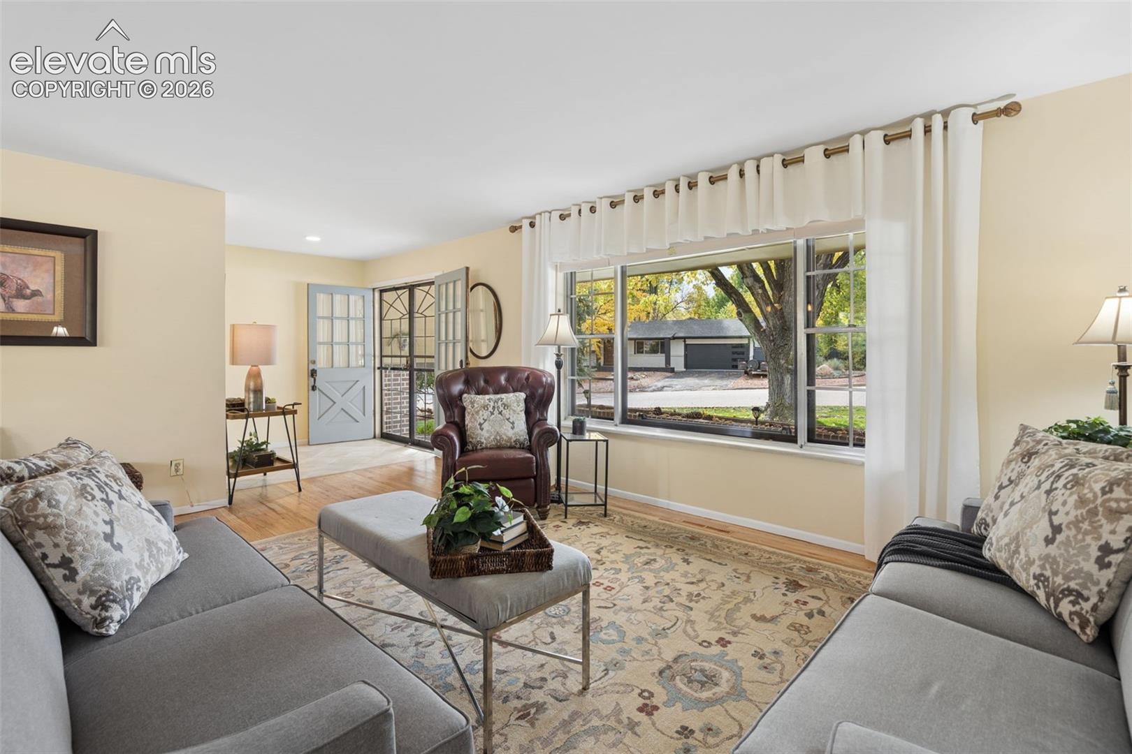 Spacious living room is one of three spaces for family and friends to gather